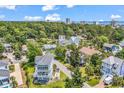 Aerial view of a lovely home with a front-facing garage in a neighborhood with mature trees at 601 46Th Ave. S, North Myrtle Beach, SC 29582