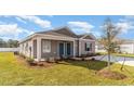 View of a cozy single-story home featuring a well-kept lawn and minimal landscaping, perfect for low-maintenance living at 659 Culmen Ct., Myrtle Beach, SC 29588