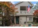 Home featuring a covered balcony, beautiful landscaping, and an American flag at 705 11Th Ave. S, North Myrtle Beach, SC 29582