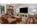 Inviting living room with a brick fireplace, wood floors, and leather sofas at 705 11Th Ave. S, North Myrtle Beach, SC 29582