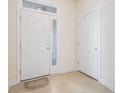 Bright entryway features tiled floors, a transom window, and white doors at 730 Pickering Dr. # 303, Murrells Inlet, SC 29576