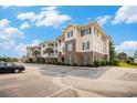 Inviting condo complex showcases brick and siding details, manicured landscaping and convenient parking at 730 Pickering Dr. # 303, Murrells Inlet, SC 29576