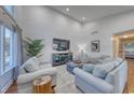 The stylish living room features soaring ceilings, textured walls, and comfortable seating arrangements at 800 S 9Th Ave. S # A-1, North Myrtle Beach, SC 29582