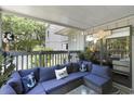 Relaxing covered patio featuring comfortable wicker seating with beach-themed decorations and nautical accents at 88 Salt Marsh Circle # 22F, Pawleys Island, SC 29585