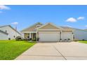 Charming tan home with a two car garage, manicured lawn, and beautiful landscaping at 915 Sorano St., Myrtle Beach, SC 29579