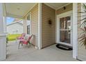 Welcoming front porch with cozy seating area to relax and enjoy the outdoors at 915 Sorano St., Myrtle Beach, SC 29579