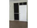 Condo entryway with a white louvered door, screen window, and a unit number; creates a clean and inviting access point at 9571 Shore Dr. # 318, Myrtle Beach, SC 29572
