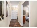 Neutral hallway featuring tile floors, a decorative mirror, and a bedroom entrance at 100 North Beach Blvd. # 710, North Myrtle Beach, SC 29582