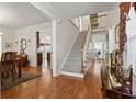 Open entryway with hardwood floors, a staircase, and a view into the kitchen at 1044 Martin Ln., Conway, SC 29526