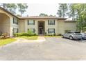 Exterior view of a condo complex showcasing the building's architecture and surrounding greenery at 108 Pipers Ln. # 108, Myrtle Beach, SC 29575