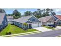 Aerial view of a well-maintained single Gathering home with a two car garage, landscaped yard and inviting porch at 1352 Jolly Roger Dr., North Myrtle Beach, SC 29582