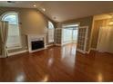 Bright living room with a fireplace and French doors leading to a sunroom at 1428 Saint Thomas Circle # B-1, Myrtle Beach, SC 29577