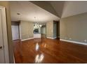 Open-concept living room with hardwood floors and a view into the kitchen at 1428 Saint Thomas Circle # B-1, Myrtle Beach, SC 29577