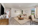 Bright living room featuring a comfortable sectional, stylish decor, and abundant natural light at 1710 Whispering Pine St., Ocean Isle Beach, NC 28469