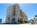 Exterior low-angle shot showcasing the condo's multiple floors and balcony views at 1903 S Ocean Blvd. # 1110, North Myrtle Beach, SC 29582