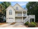 Two-story home with a two-car garage and inviting front porch at 210 Natures View Circle, Pawleys Island, SC 29585