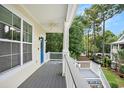 Inviting front porch with a view of the surrounding landscape at 210 Natures View Circle, Pawleys Island, SC 29585