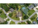 An aerial view displays a quaint home with lush landscaping, surrounded by neighboring properties and a winding street at 216 Deer Trace Circle, Myrtle Beach, SC 29588