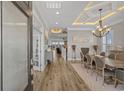 Grand entrance with wood floors, tray ceiling with accent lighting, and views of the living spaces at 397 St. Julian Ln., Myrtle Beach, SC 29579