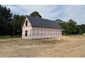 New construction home featuring a metal roof, ready for customization at 402 S Magnolia Ave., Andrews, SC 29510
