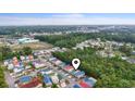Aerial view showcasing colorful houses in a coastal community surrounded by trees and waterways under a bright sky at 4331 Grande Harbour Blvd., Little River, SC 29566