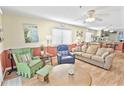 Cozy living room features a mix of patterned chairs, a comfortable couch, and a view into the dining area at 4350 Intercoastal Dr. # 1101, Little River, SC 29566