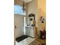 Welcoming foyer with a modern console table and a charming 'hello' sign at 4447 River Rd., Little River, SC 29566