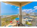 Relaxing balcony view of the ocean and nearby beach access, complete with seating area at 4525 S Ocean Blvd. # 406, North Myrtle Beach, SC 29582