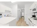 Bright kitchen with white cabinetry, appliances, and wood grain floors at 4705 Wild Iris Dr. # 201, Myrtle Beach, SC 29577