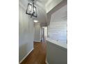 Inviting hallway with wood floors and stylish light fixture leading to an open living space at 493 Emerson Dr., Myrtle Beach, SC 29579