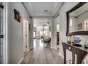 Open hallway with light wood flooring, leading to the living spaces and staircase at 5013 Sassari St., Myrtle Beach, SC 29579