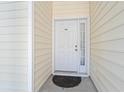 A close-up of a white front door with a window and the number 104 above the door handle at 6000 Windsor Green Way # 104, Myrtle Beach, SC 29579