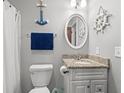Gray and white bathroom with nautical decor and granite vanity at 618 N Waccamaw Dr. # A-5, Murrells Inlet, SC 29576