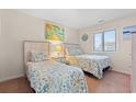 Bright bedroom featuring two beds with patterned linens and coastal-themed decor at 618 N Waccamaw Dr. # A-5, Murrells Inlet, SC 29576