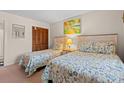 Cozy bedroom with twin beds, closet, and beach-themed artwork at 618 N Waccamaw Dr. # A-5, Murrells Inlet, SC 29576