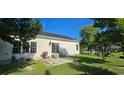 Backyard featuring a patio area with outdoor seating, well-kept lawn, mature trees, and a fenced perimeter at 618 Wintercreeper Dr., Longs, SC 29568