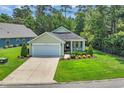 Inviting single-story home with a well-kept lawn and charming front porch at 628 Grand Cypress Way, Murrells Inlet, SC 29576