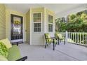 Inviting front porch with comfortable seating, plants, and a decorative front door at 628 Grand Cypress Way, Murrells Inlet, SC 29576