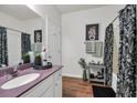 Bathroom features a vanity, mirror, and shower with decorative curtain at 6309 Sweetwater Blvd., Murrells Inlet, SC 29576