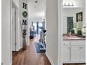 Hallway with hardwood floors with view to living room and bathroom at 6309 Sweetwater Blvd., Murrells Inlet, SC 29576
