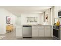 Bright, minimalist kitchen with white cabinetry, stainless steel dishwasher, and open layout at 6347 Swainson Street Sw, Ocean Isle Beach, NC 28469