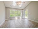 Bright sunroom featuring a ceiling fan and a skylight with a window door to the backyard at 648 Sunnyside Dr. # 102, Murrells Inlet, SC 29576