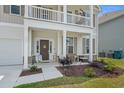 Charming front porch with decorative accents, landscaping, and a welcoming entrance on a sunny day at 753 Enchantment Loop, Myrtle Beach, SC 29588