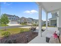 View from the porch showcases the homes across the street with manicured lawns and neighborhood charm at 753 Enchantment Loop, Myrtle Beach, SC 29588