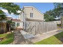 Backyard view featuring a wooden fence, lush grass, and a stone pathway at 800 9Th Ave. S # E-4, North Myrtle Beach, SC 29582