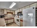 Bright kitchen with white appliances and stone backsplash at 912 N Waccamaw Dr. # 904, Garden City Beach, SC 29576