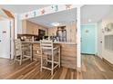 Kitchen with wood cabinets, wood accent wall and two bar stools at 9820 Queensway Blvd. # 502, Myrtle Beach, SC 29572