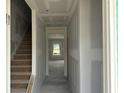 Bright hallway with stairs, showcasing the home's layout and potential for customization at 1045 Jase Dr., Longs, SC 29568