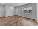 Bright bedroom featuring wood-look flooring, two closets and a large window at 1046 Laconic Dr., Myrtle Beach, SC 29588