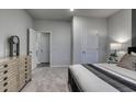 Calm bedroom showcases soft gray walls, light carpet, and neutral decor with a comfortable bed and wooden dresser at 1050 Laconic Dr., Myrtle Beach, SC 29588